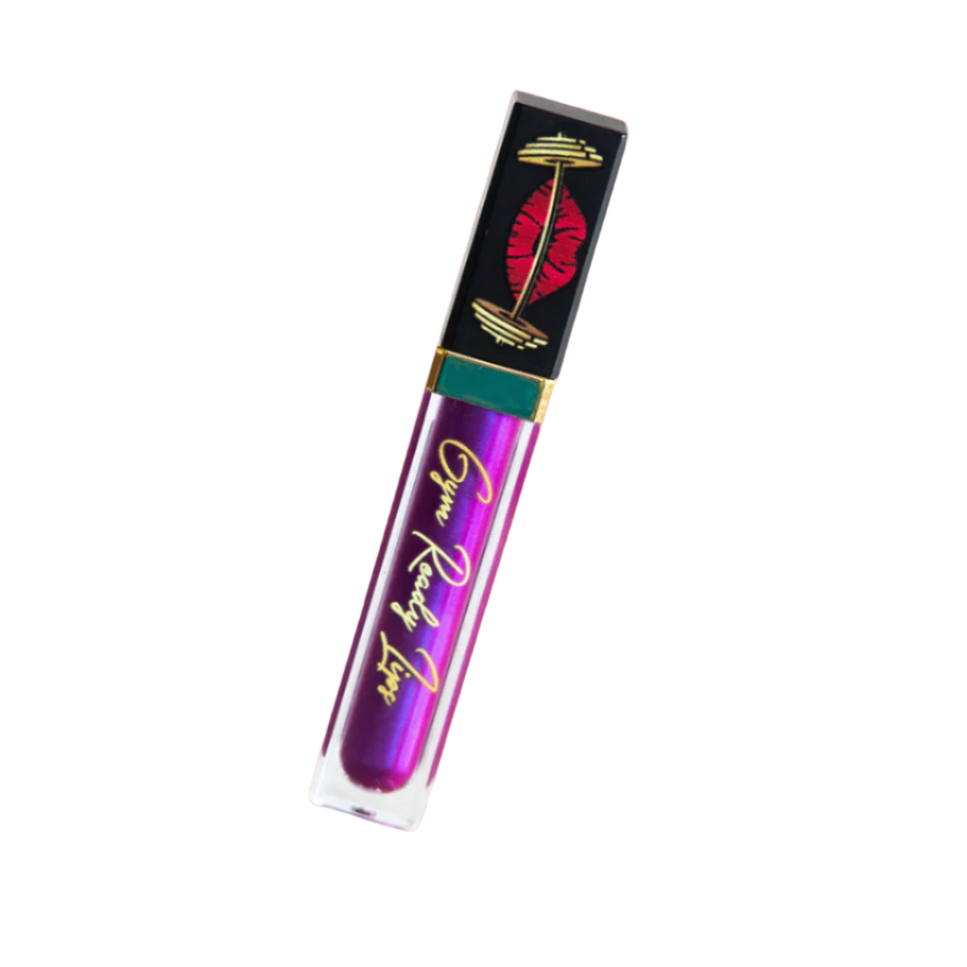 Purple lip gloss tube with black and gold packaging on a white background