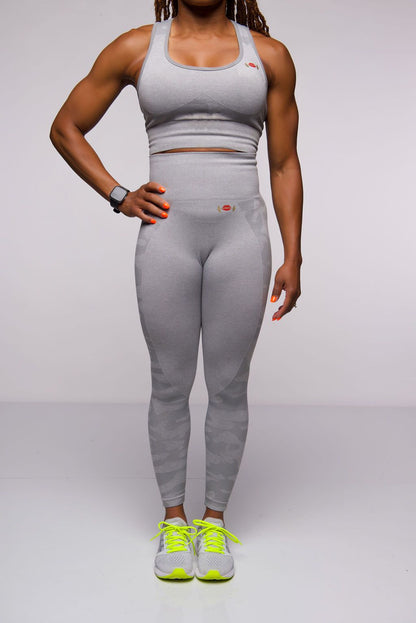 one young woman wearing grey camoflage Yogapants at the gym
